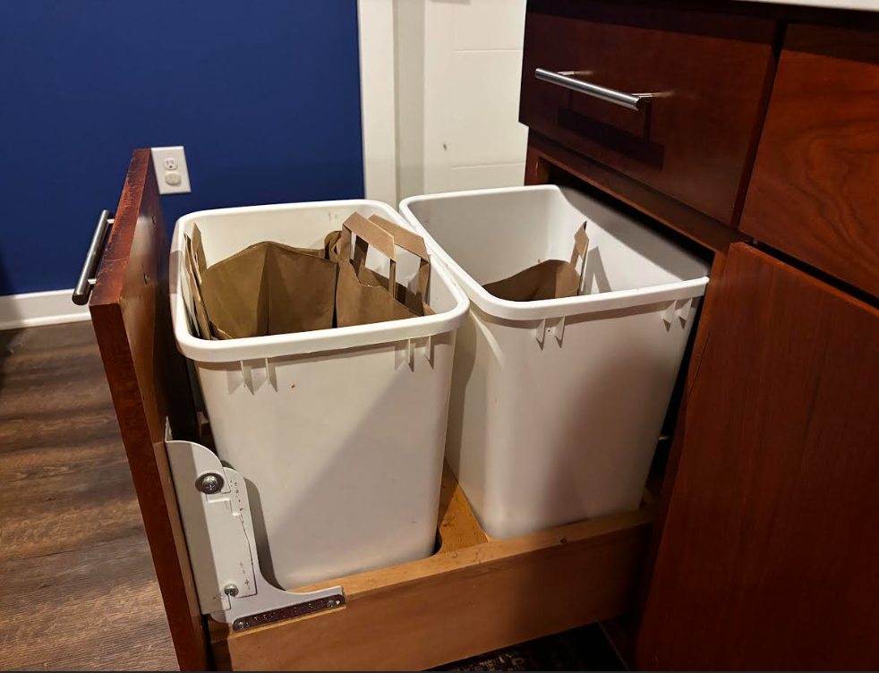 Example of an insufficient gap: a Trash Shield pressed against tight cabinet clearance, illustrating a setup where it will not fit